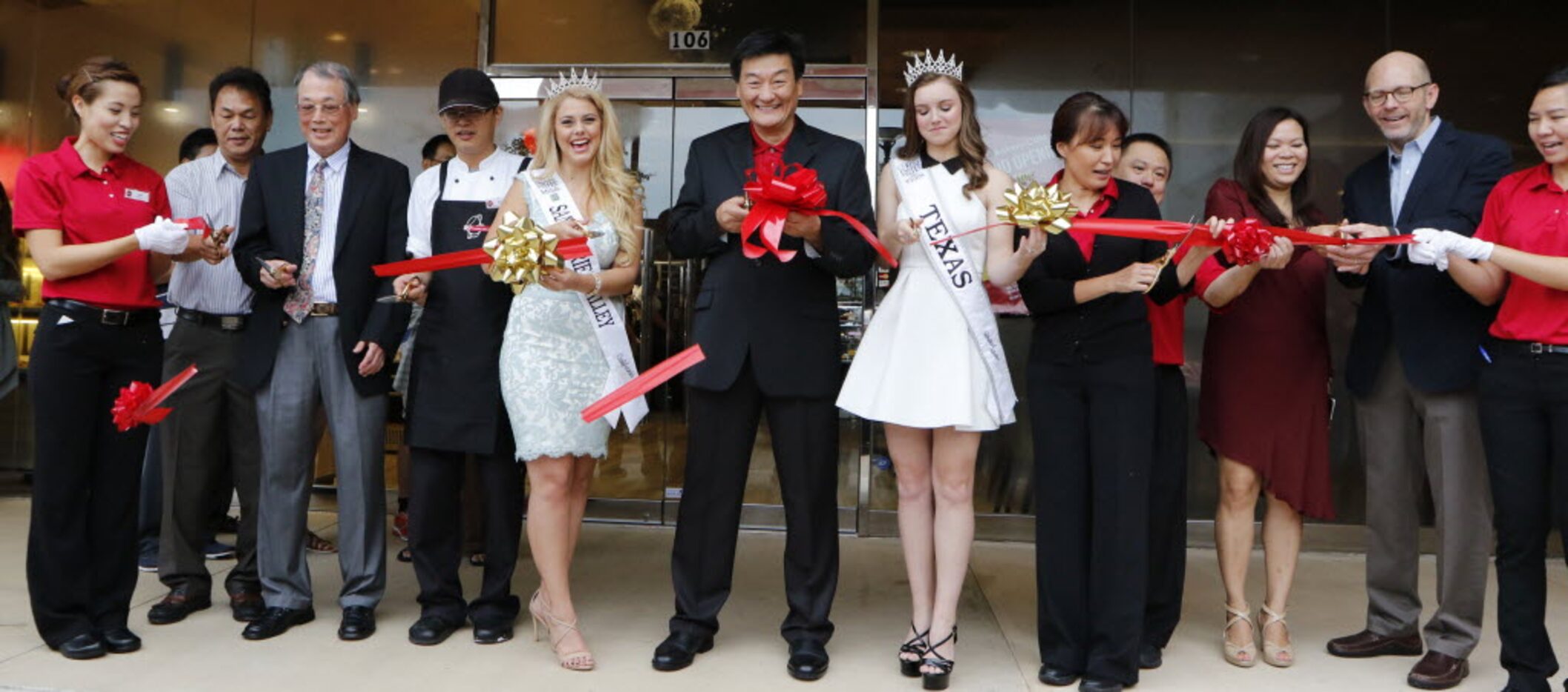 Charles Wu, center, Director Operations Division 85C Bakery Cafe cuts the ribbon at the...