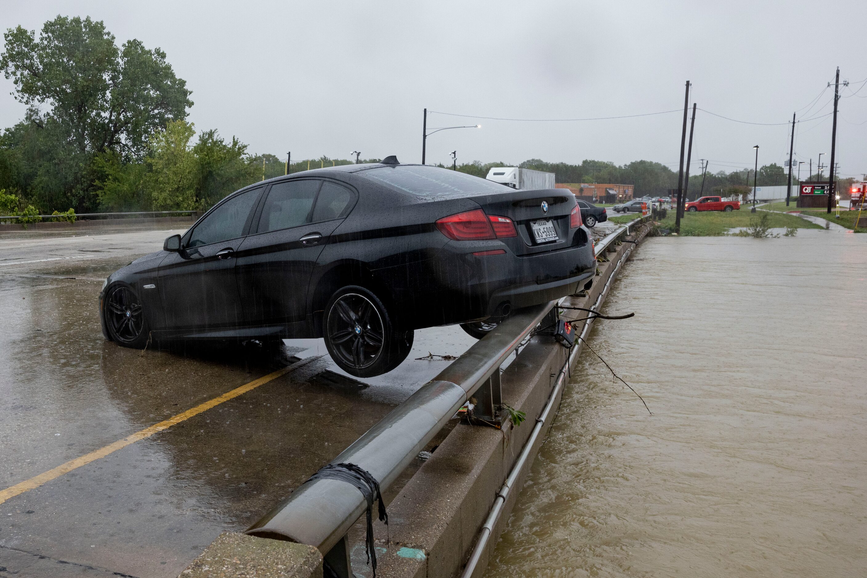 A BMW sets on the rail overlooking the flooded South Mesquite River on Monday, Aug. 22,...