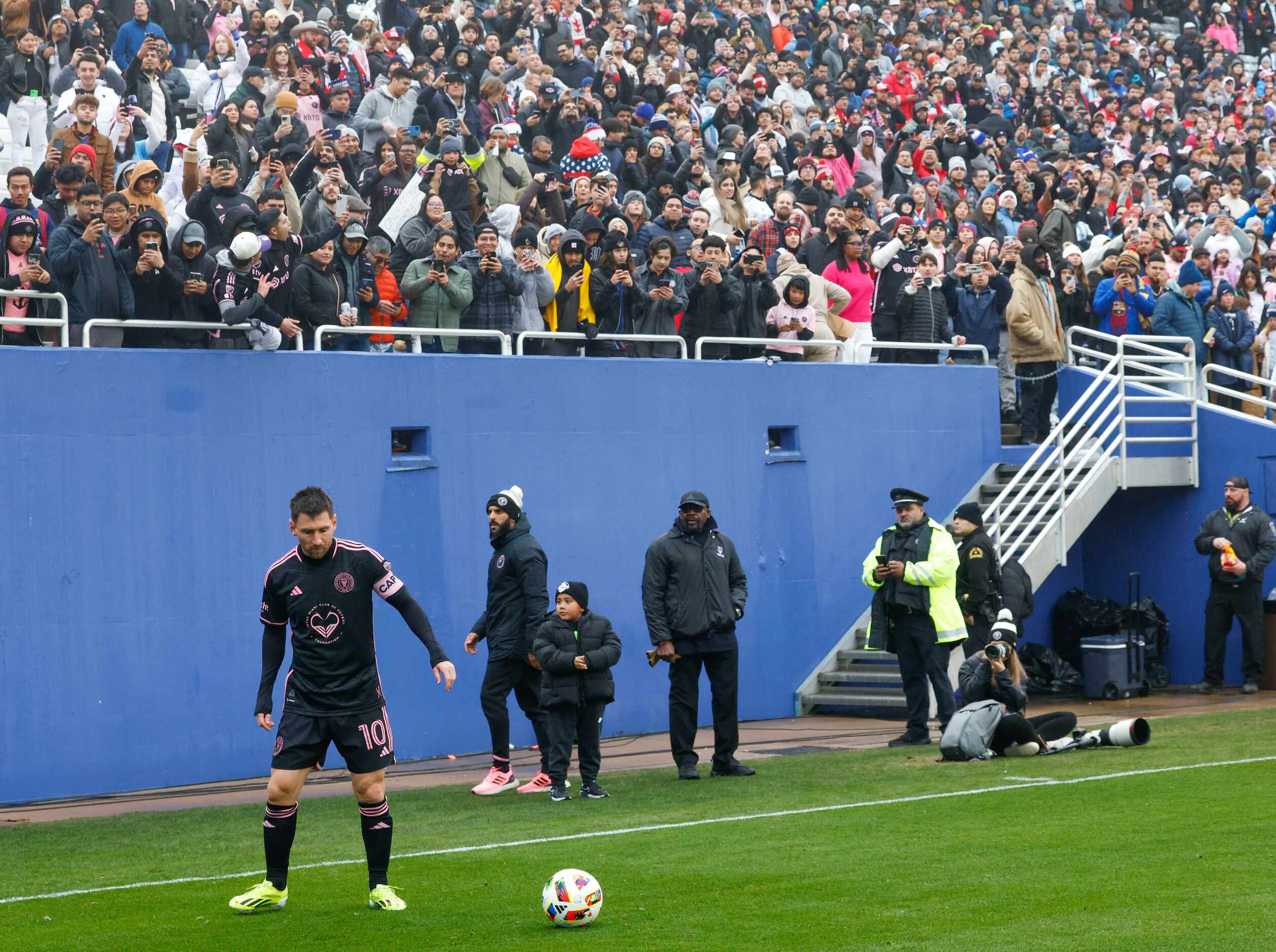 Fans cheer for Inter Miami forward Lionel Messi as he prepares to take a corner kick against...