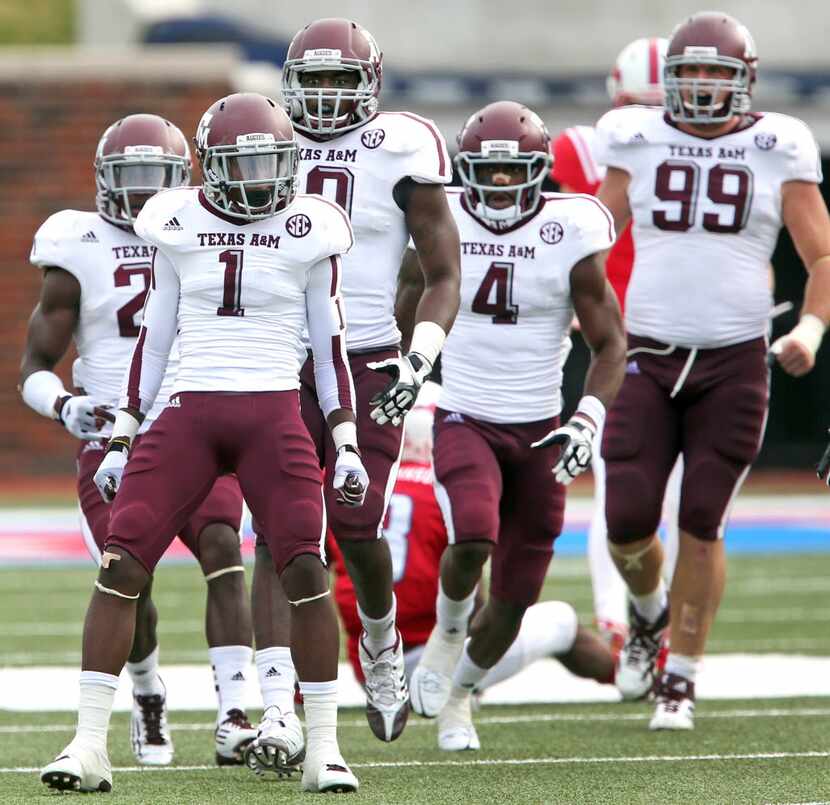 Aggie defenders De'Vante Harris (1), Sean Porter (10), Toney Hurd Jr. (4) and Spencer Nealy...