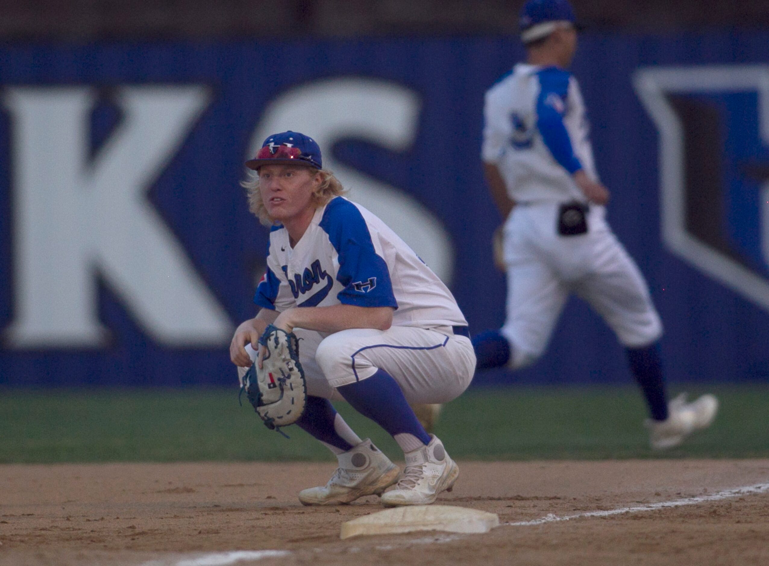 Hebron first baseman Trent McCown (16) reacts after an overthrow allowed a Coppell batter to...