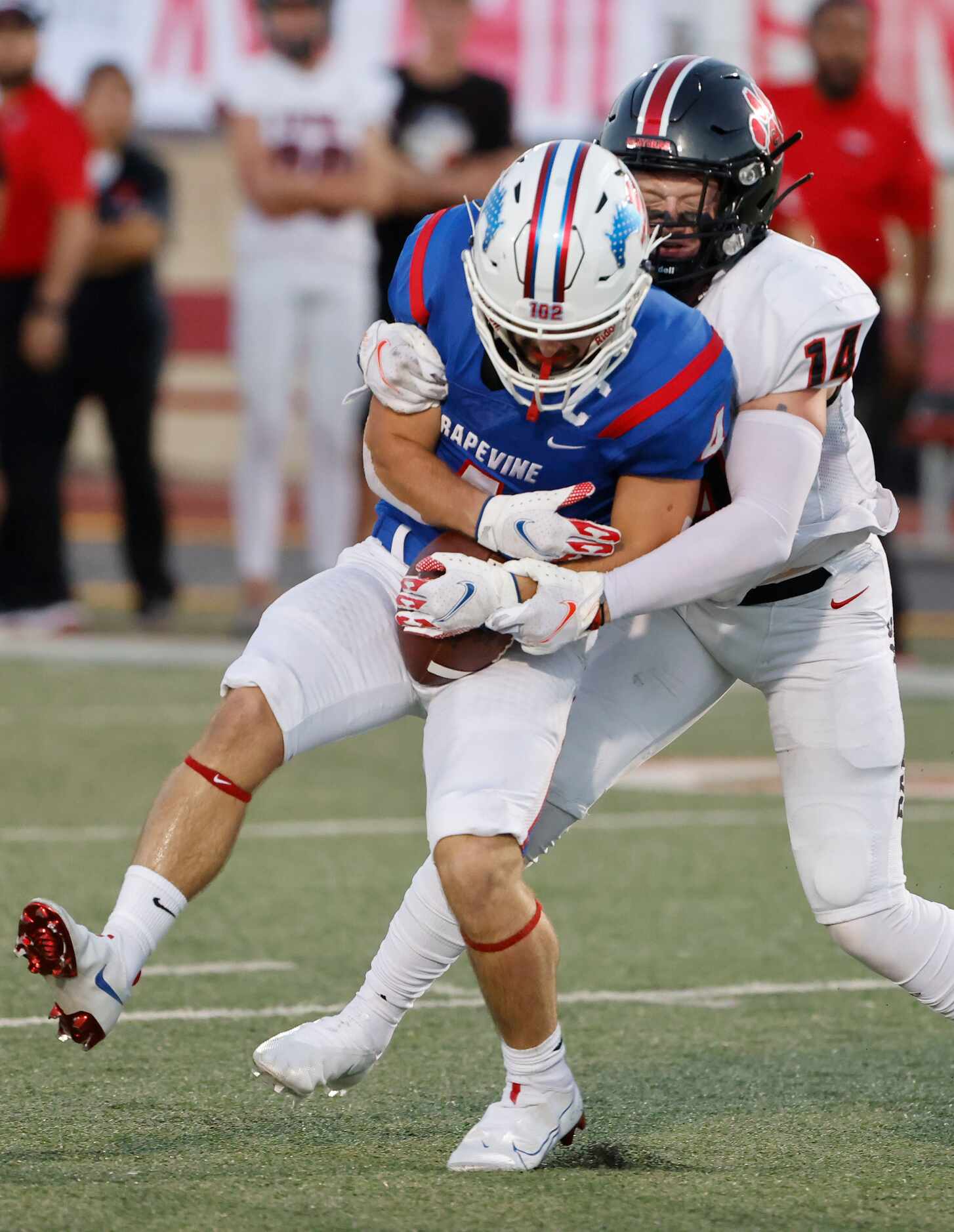 Grapevine receiver Parker Polk (4) makes a reception as he is tackled by 
Colleyville...