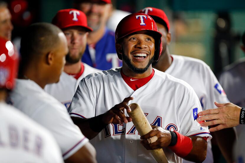Texas Rangers shortstop Elvis Andrus (1) smiles big as he is congratulated by teammates...