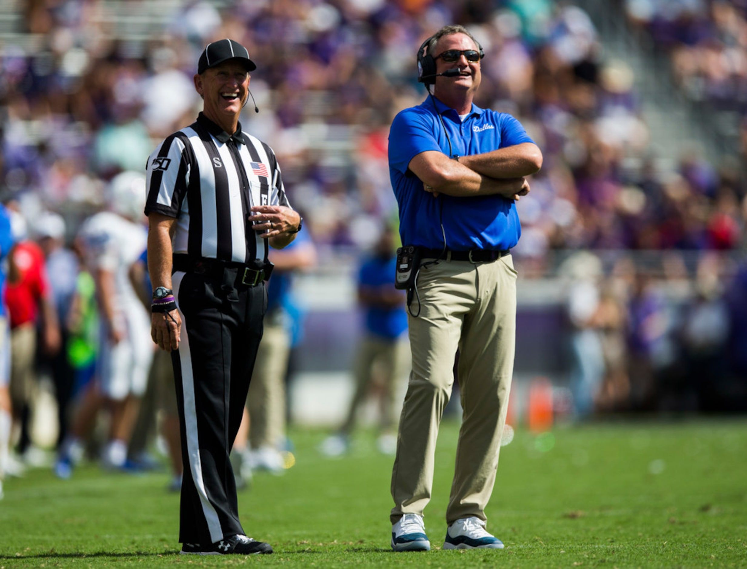 Southern Methodist Mustangs head coach Sonny Dykes reviews a play during the first quarter...