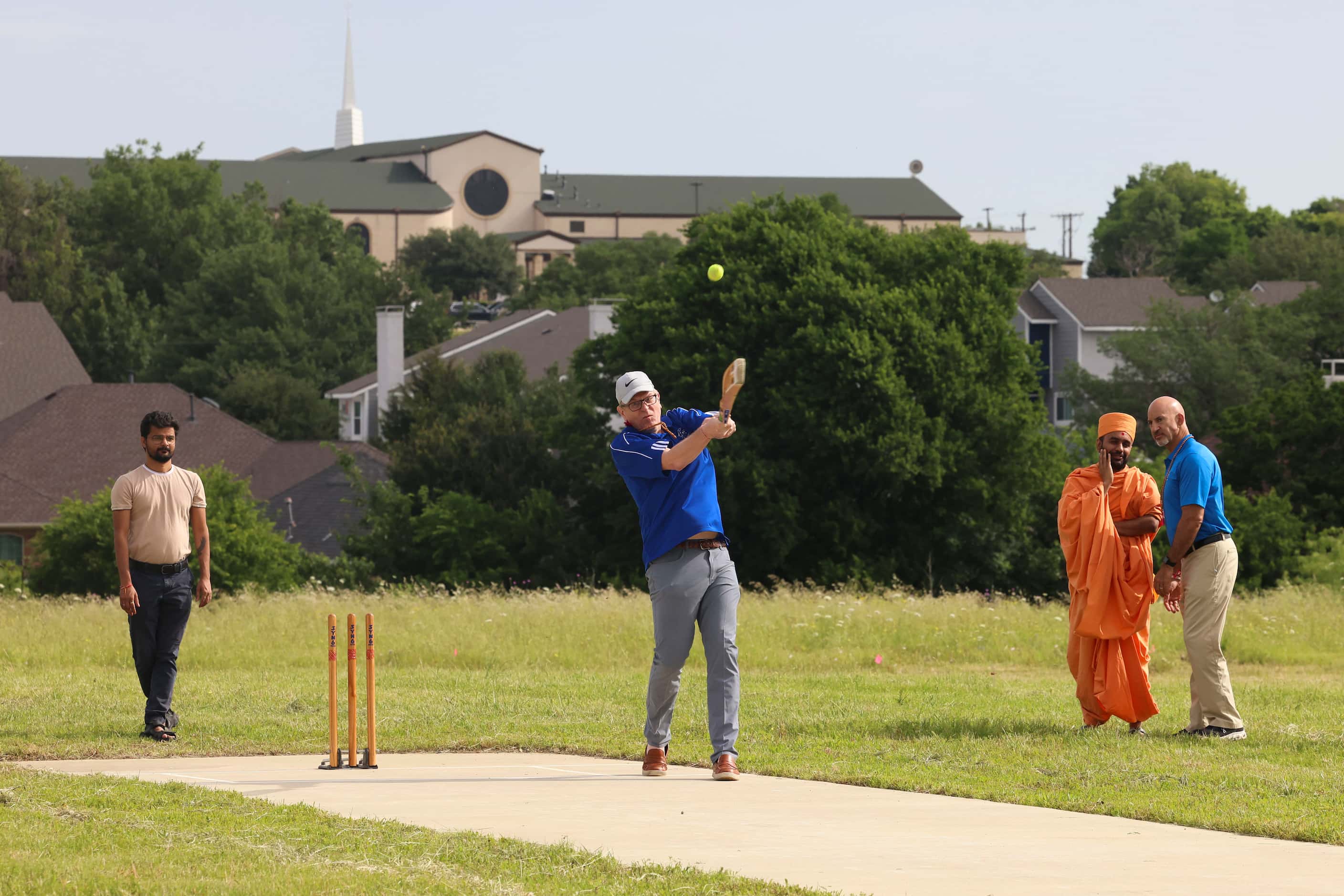 Irving city council member Mark Cronenwett, bats during a ceremonial cricket game ahead of a...