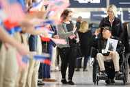 D-Day veteran Seymour Tipper salutes as he is greeted at Charles de Gaulle airport,...