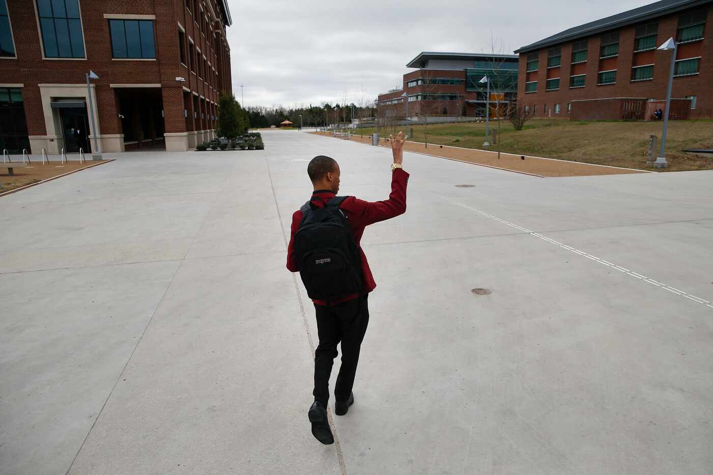 Jaylon Miller waves to a friend across the campus common area at the University of North...