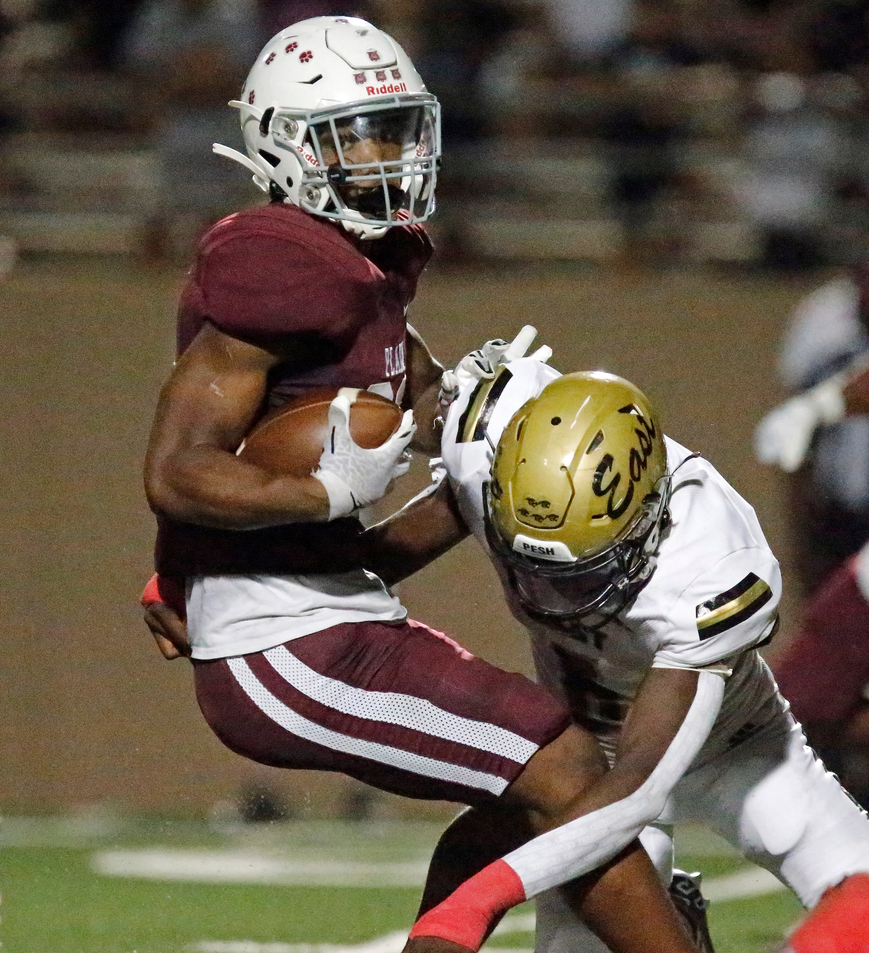 Plano Senior High School running back Kameron Jones (26) is tackled by Plano East High...