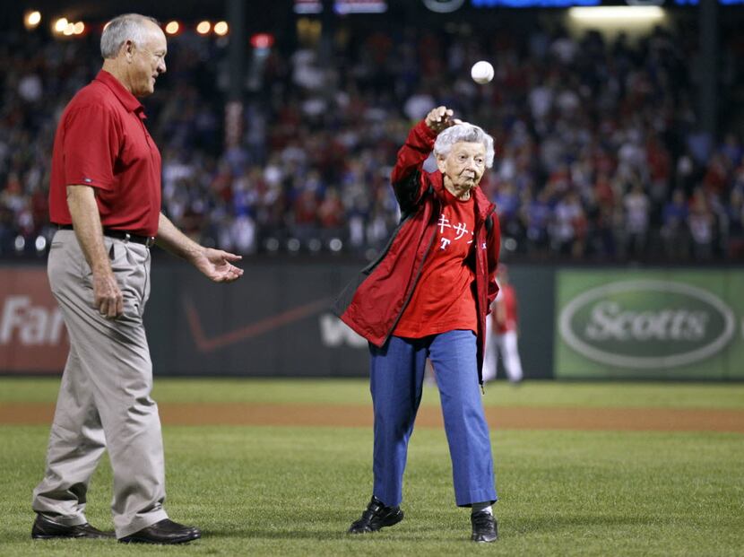 Sister Frances Evans throws out the ceremonial first pitch with the escort by Texas Rangers...
