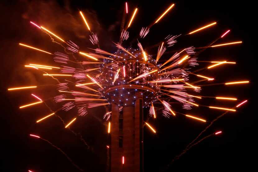 Fireworks fly from Reunion Tower during the New Year's Eve event in Dallas on December 31,...
