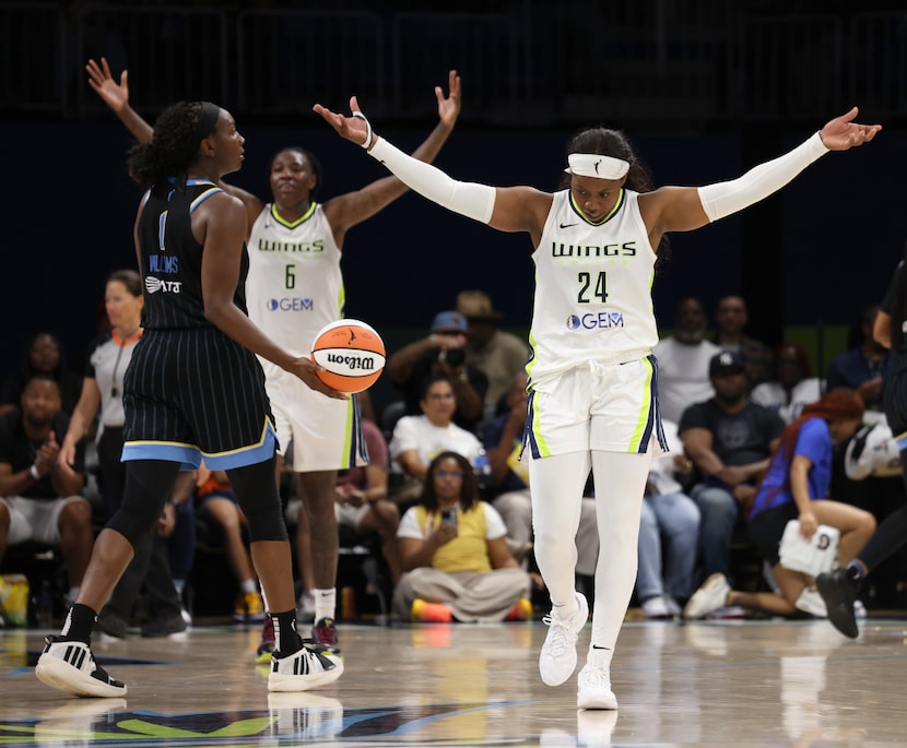 Dallas Wings guard Arike Ogunbowale (24), right, raises her arms, as does forward Natasha...