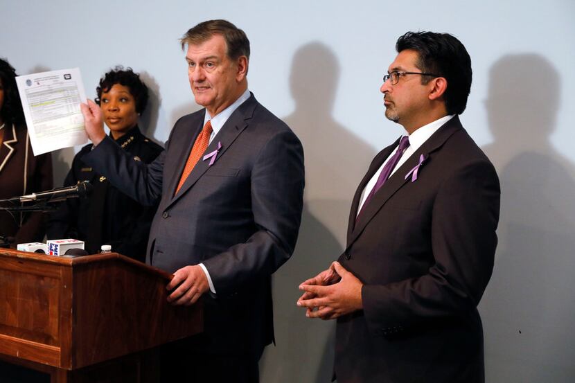 Dallas Mayor Mike Rawlings (third from left) holds a copy of the Domestic Violence Lethality...
