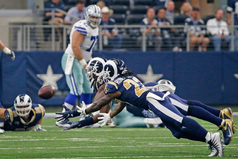 Los Angeles Rams Mark Barron (26) dives with teammate Nickell Robey-Coleman (23) to...