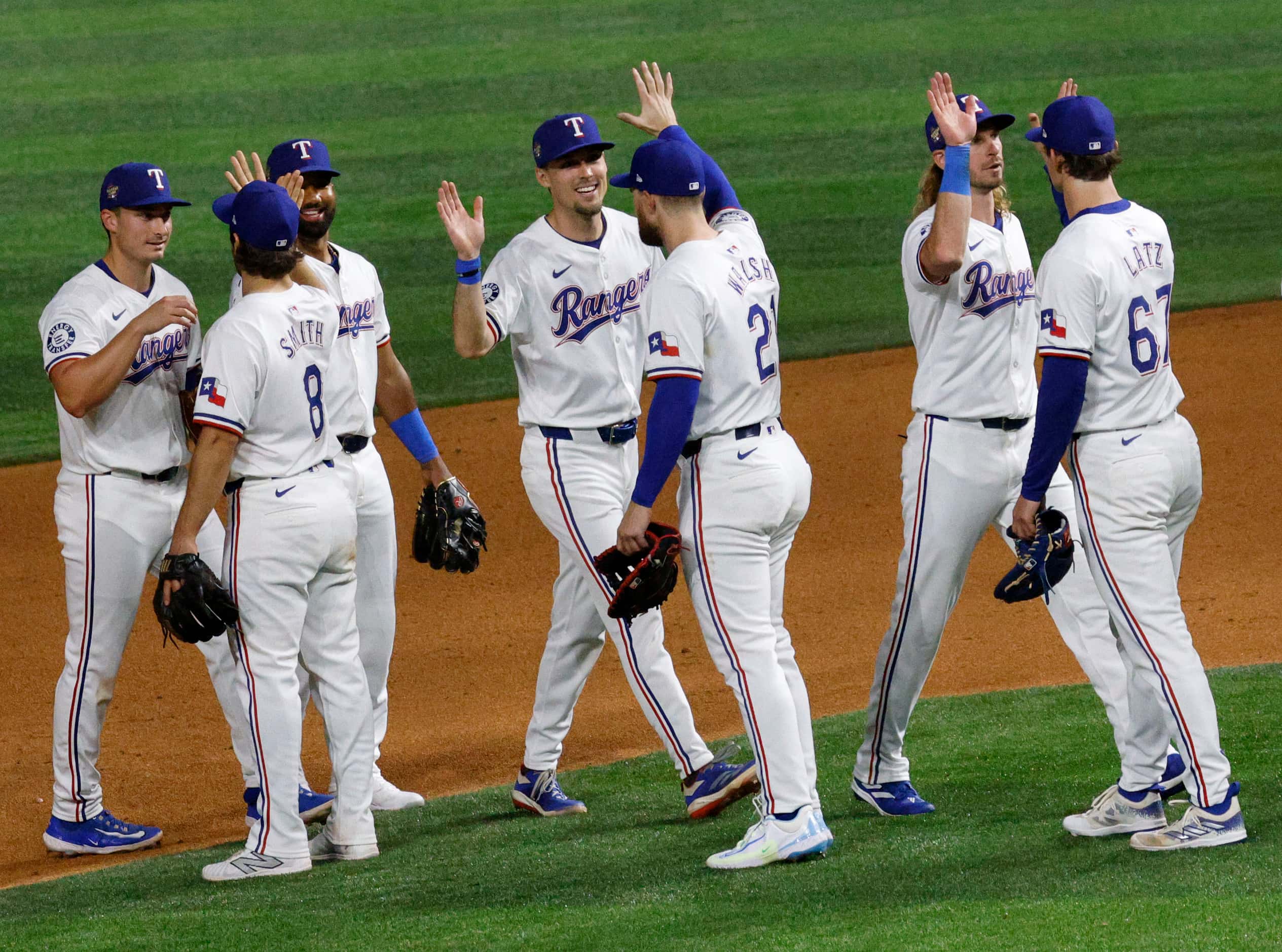 Texas Rangers players celebrate their 10-2 victory against the Houston Astros after a...