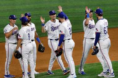 Texas Rangers players celebrate their 10-2 victory against the Houston Astros after a...