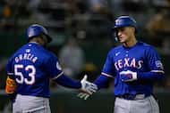 Texas Rangers' Corey Seager, right, celebrates with Adolis García, right, after hitting a...