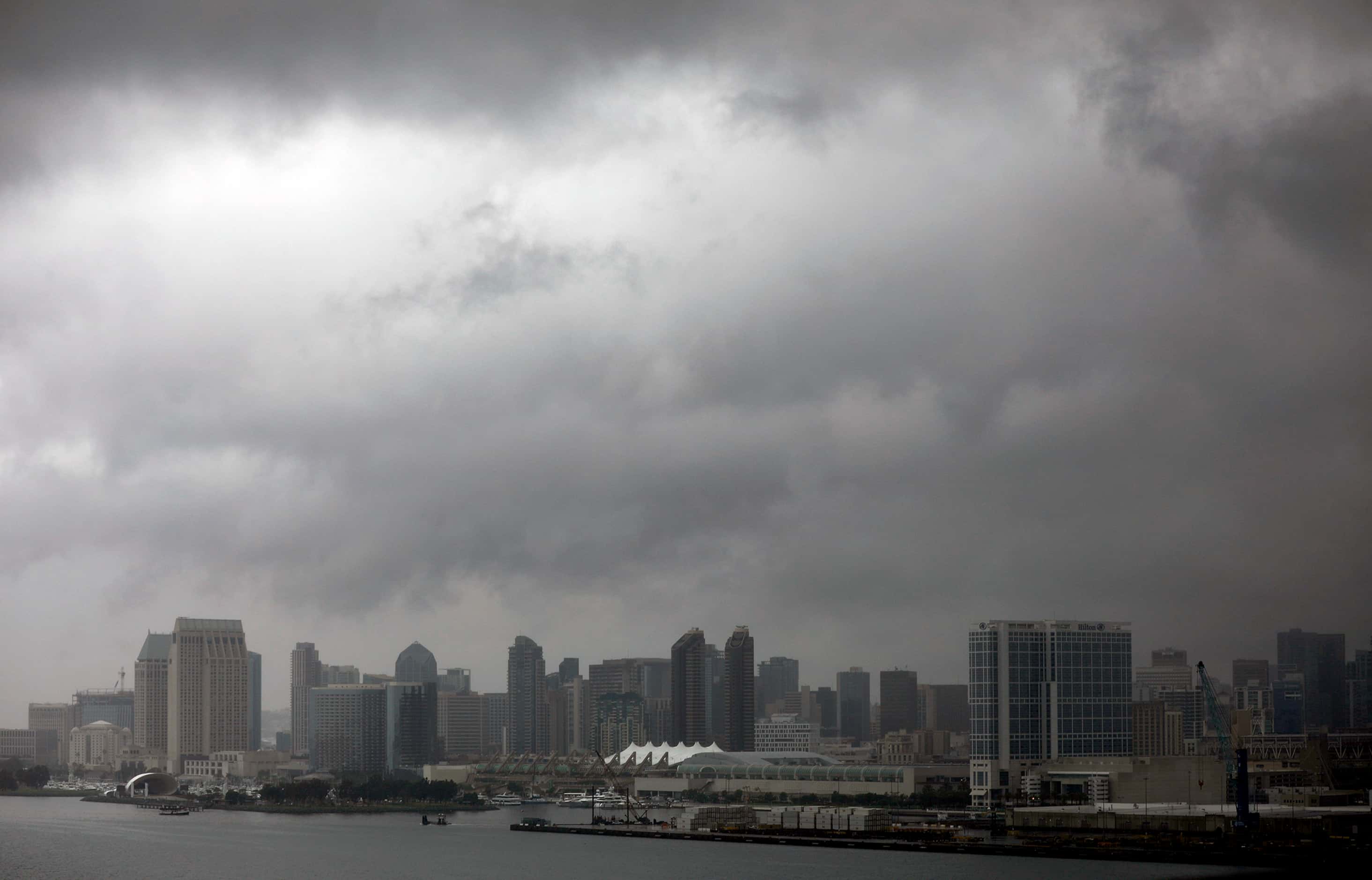 Dark clouds form over downtown San Diego as Tropical Storm Hilary passes through the area on...