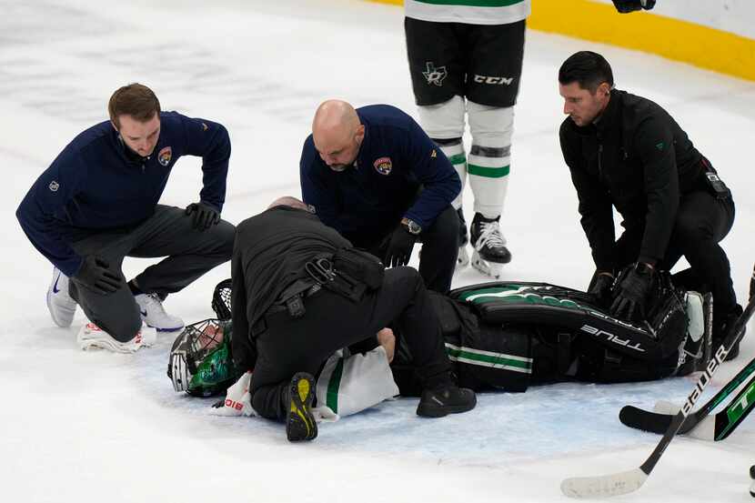 Dallas Stars goaltender Scott Wedgewood is attended to after a play during the second period...