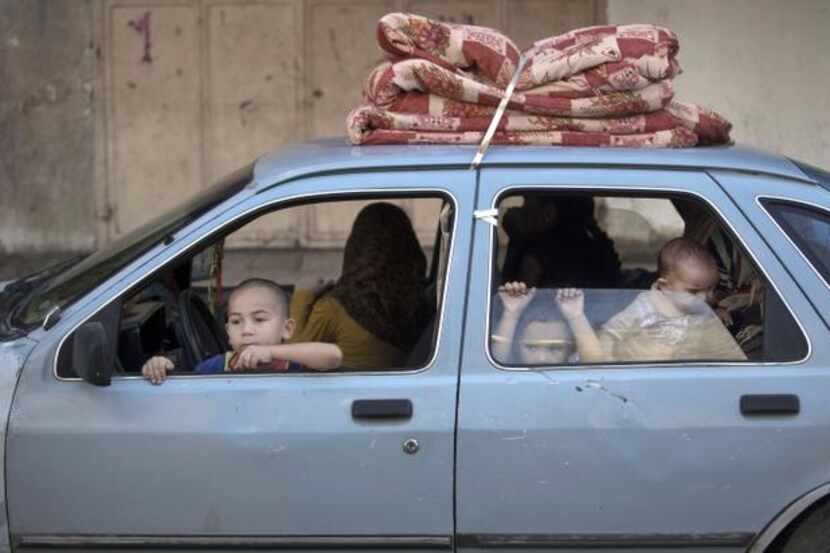 
Palestinian families left their homes in a Gaza City neighborhood on Friday in fear of...