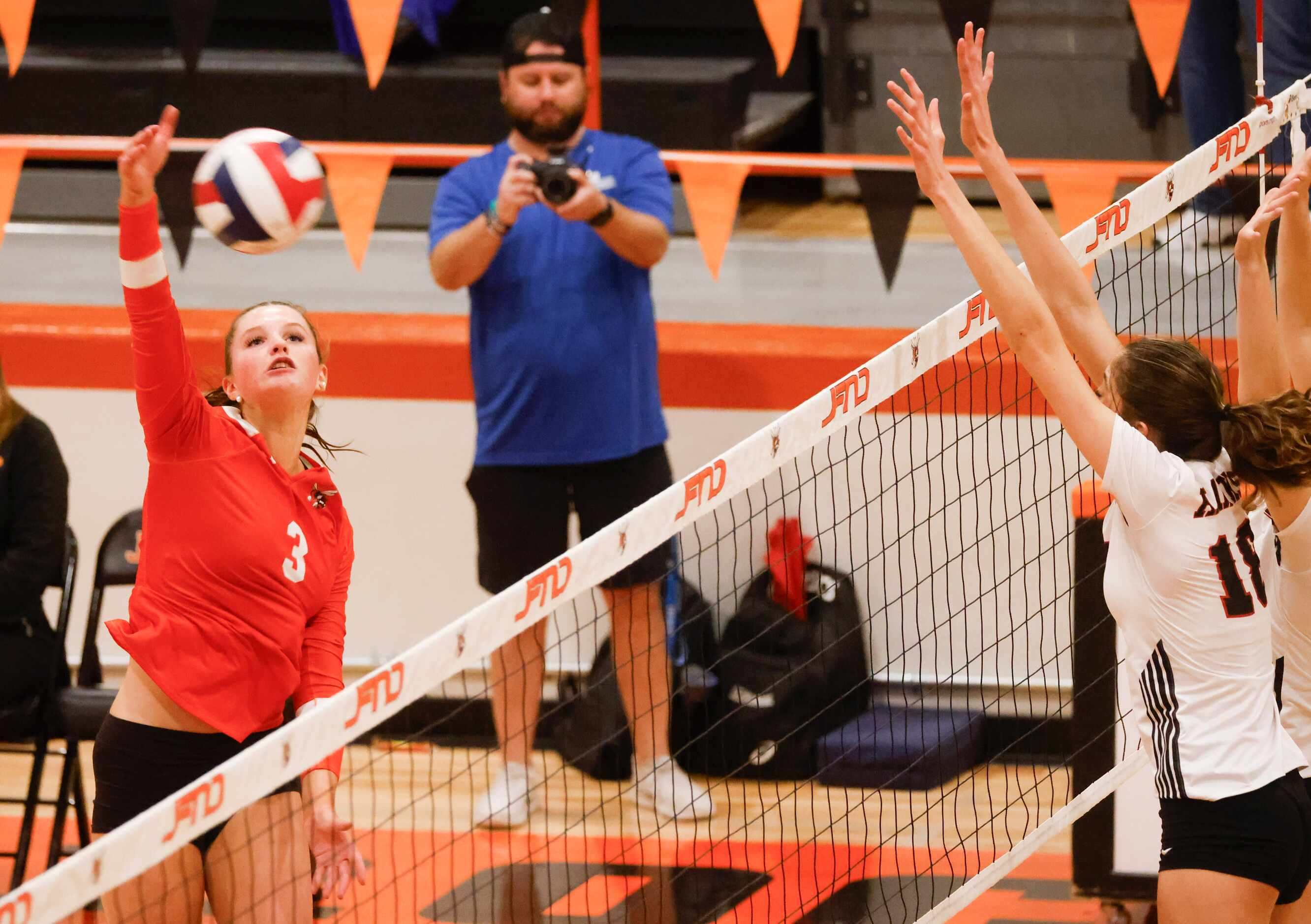 Rockwall high’s Harley Krause (left) spikes the ball against Rockwall heath’s Abby Lemp (18)...