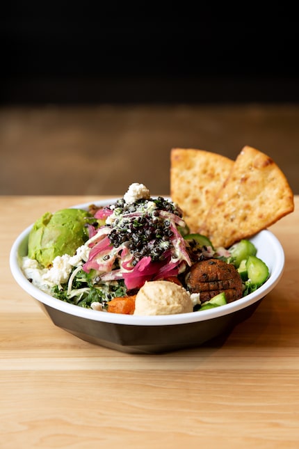 One of Cava's chef-curated bowls is the Lentil Avocado Bowl, which is built with falafel,...