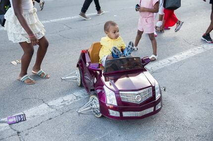 Sterling Shepard, 1, of Austin, relaxes in his toy car during SXSW Interactive in Austin on...