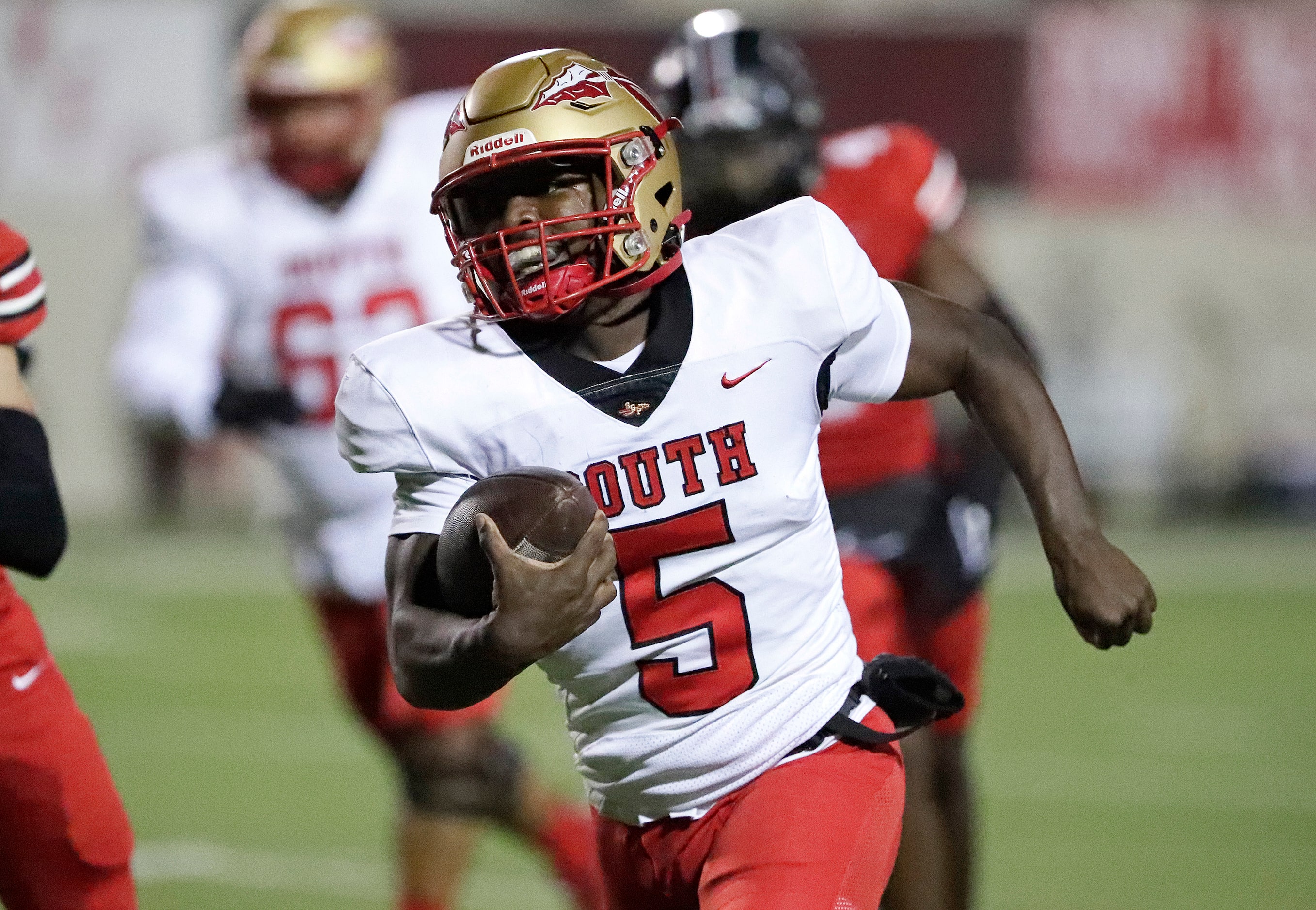 South Grand Prairie High School quarterback Daylon Brooks (5) runs the football during the...