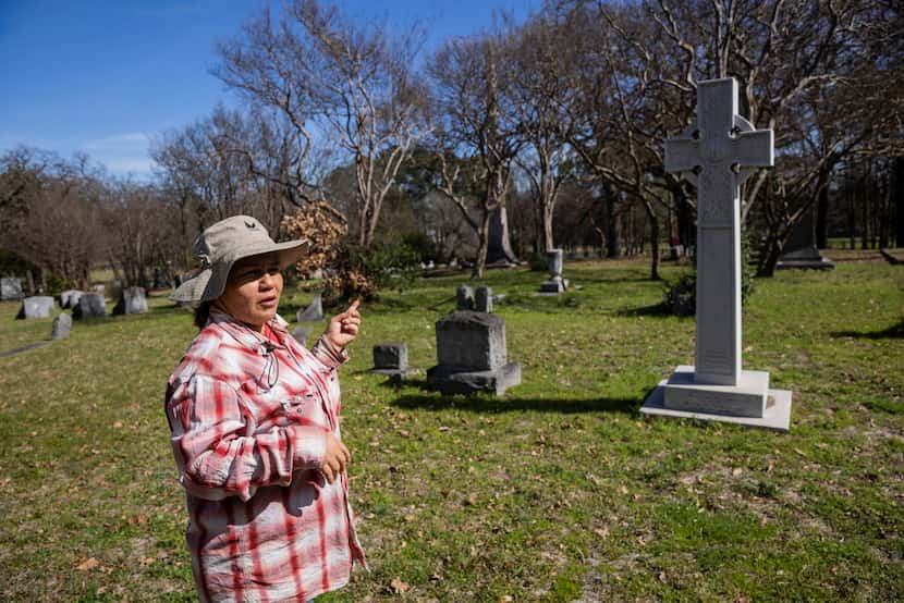 Oakland Cemetery administrator Monica Newbury points to her favorite stone in the graveyard,...