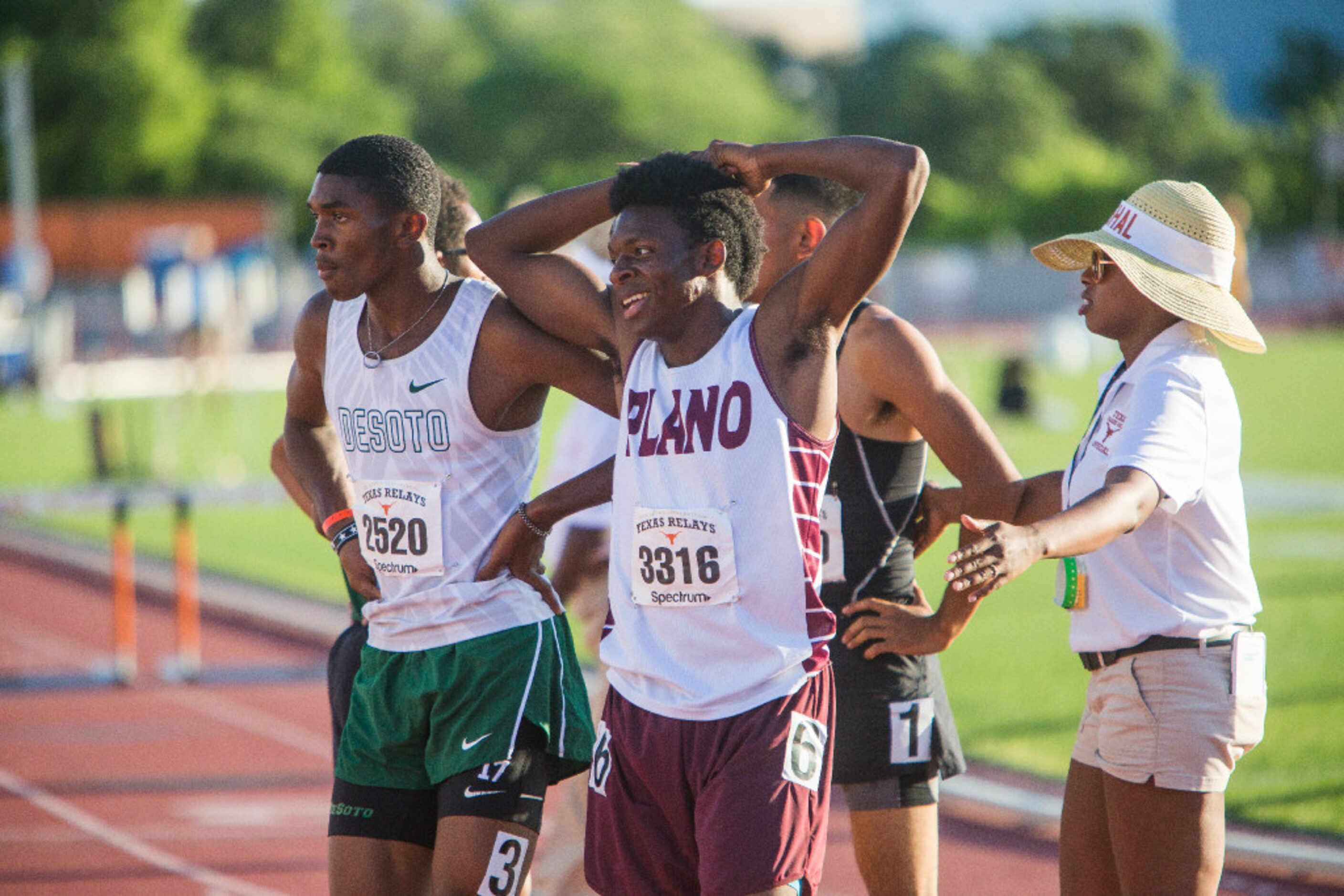 Plano's Charles Brockman, center, smiles after the finish of the boys 300 meter hurdles...