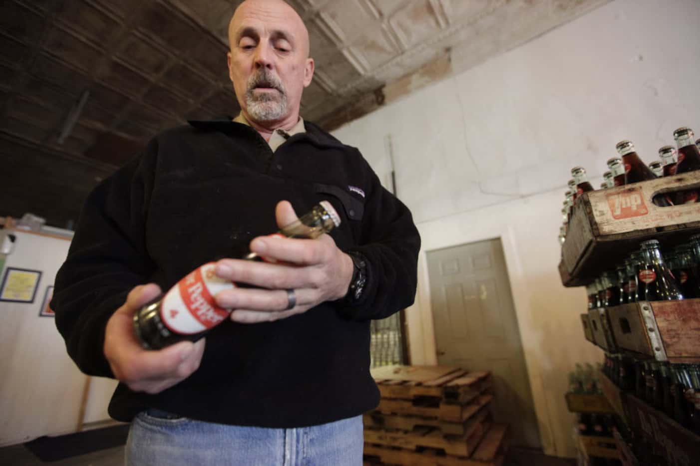 Jeff Kloster, owner of Dublin Bottling Works, looks over one of the last bottles Dr Pepper...