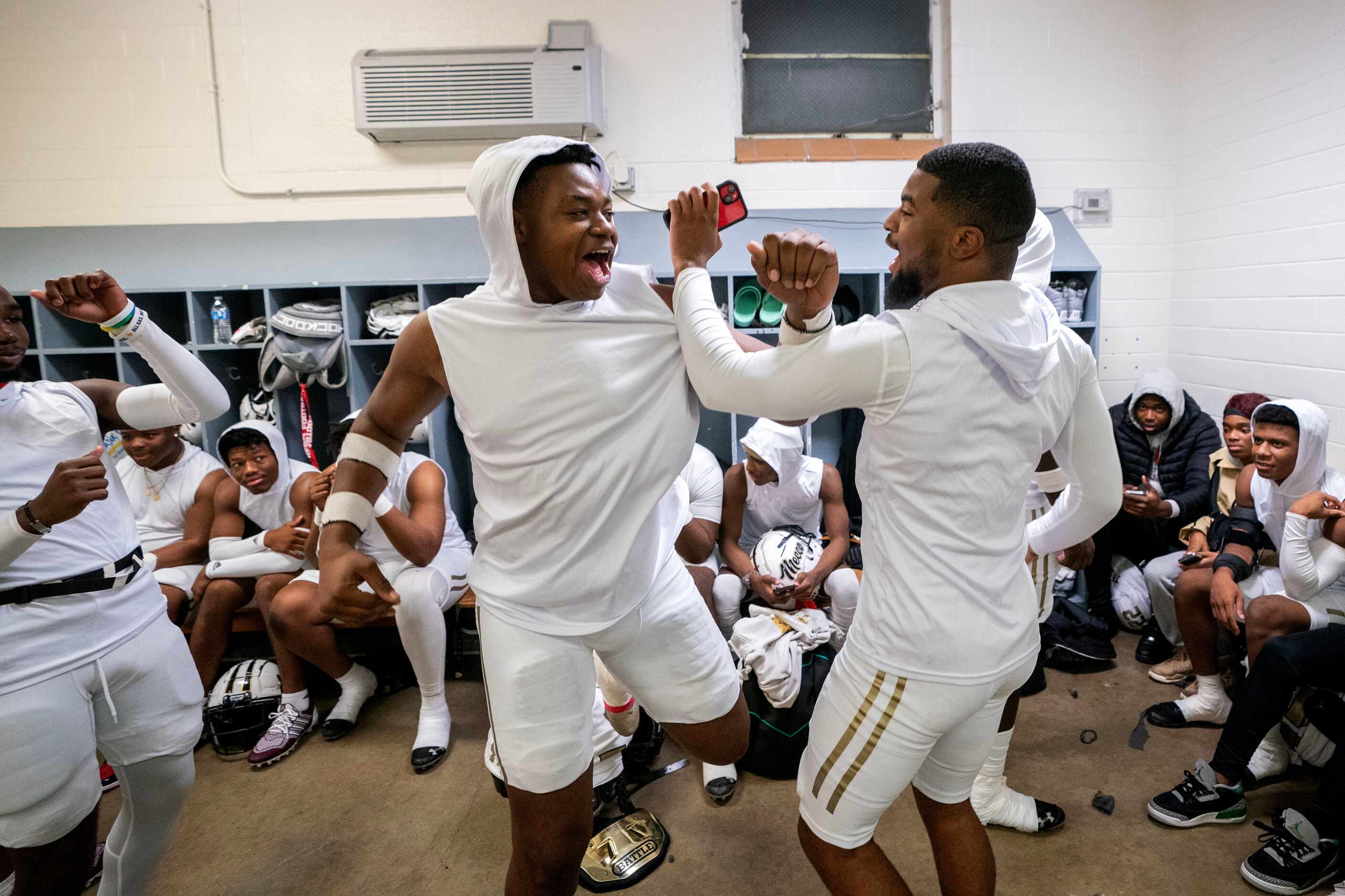 South Oak Cliff’s Ksean Jackson, left, and Torey Simon dance to music in the locker room as...