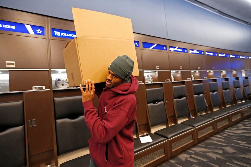 Dallas Cowboys wide receiver Brice Butler carries a box after he cleans out his locker at...