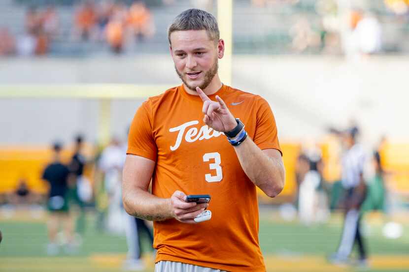 Texas quarterback Quinn Ewers prepares for the team's NCAA college football game against...