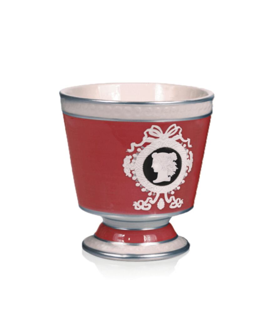 The double-wick Laurier candle, which burns for 70 hours, is housed in a ceramic container...