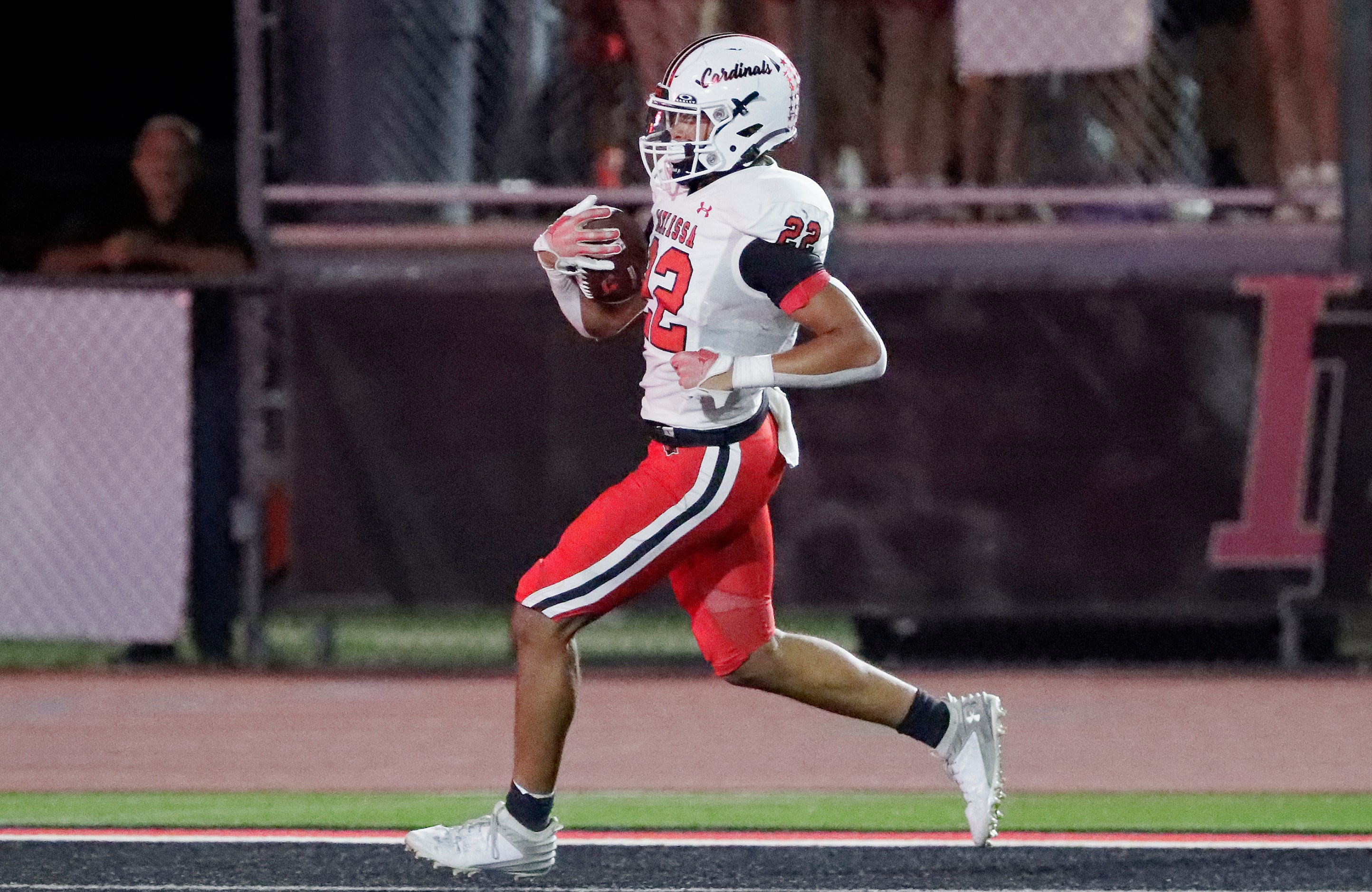 Melissa High School running back Jeremiah Tabor (22) scores a touchdown during the first...