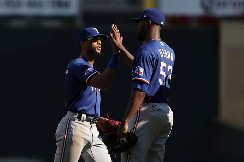 Texas Rangers' Leody Taveras, left, celebrates with Taylor Hearn, right, after defeating the...