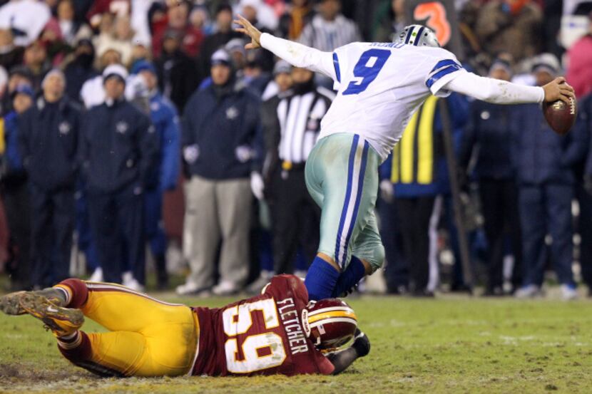 Dallas Cowboys quarterback Tony Romo (9) is sacked by Washington Redskins inside linebacker...
