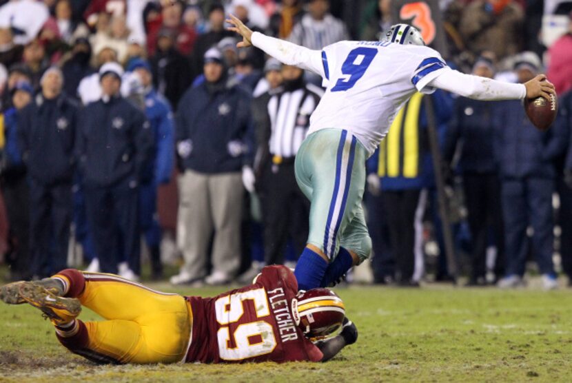 Dallas Cowboys quarterback Tony Romo (9) is sacked by Washington Redskins inside linebacker...