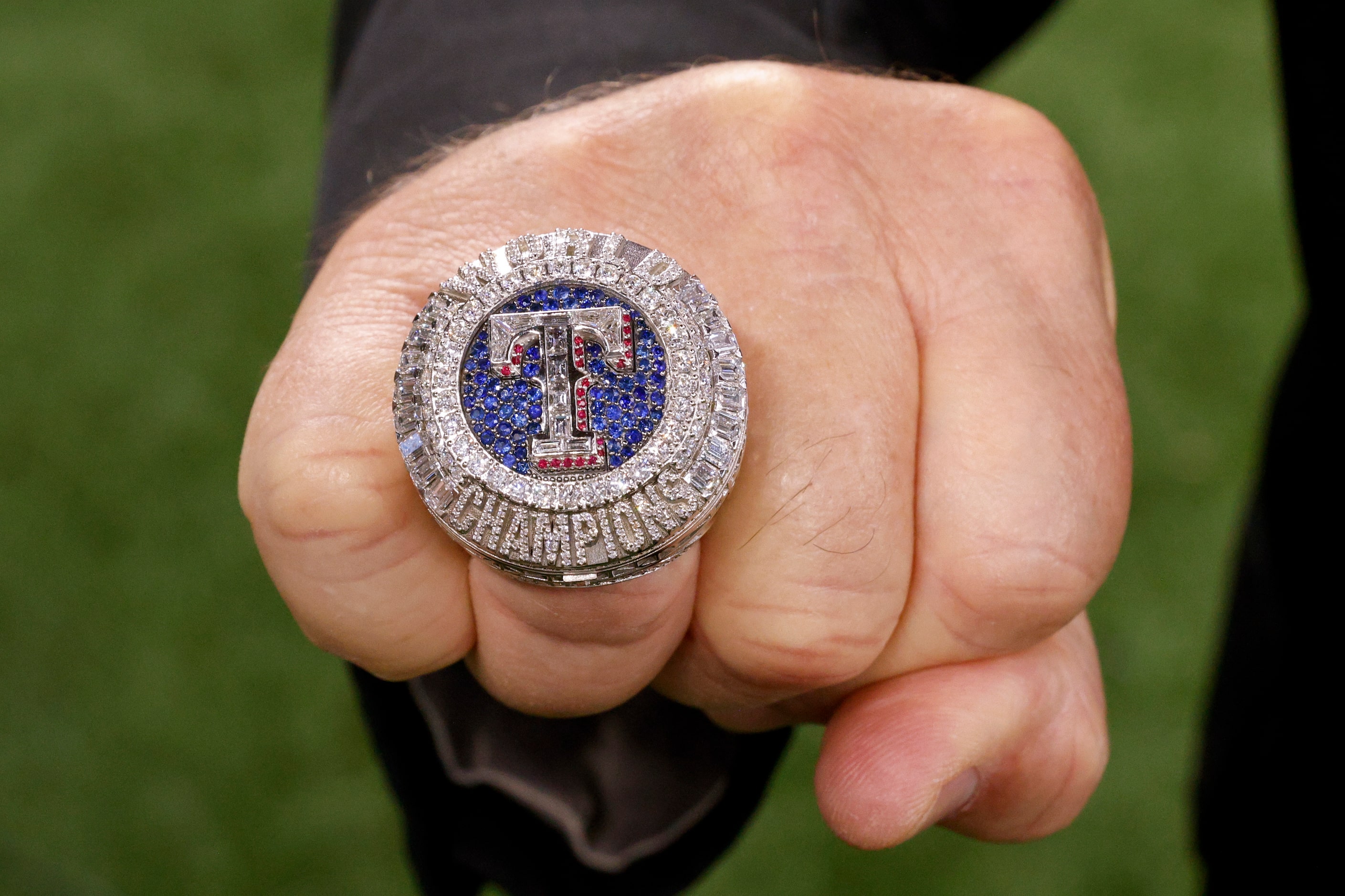 Chuck Morgan, Texas Rangers public address announcer, shows off his World Series...