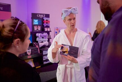 Double Dare Spa Sales Rep Austin Brook, center, shows Viktoriya Erickson, left, and Andrew...