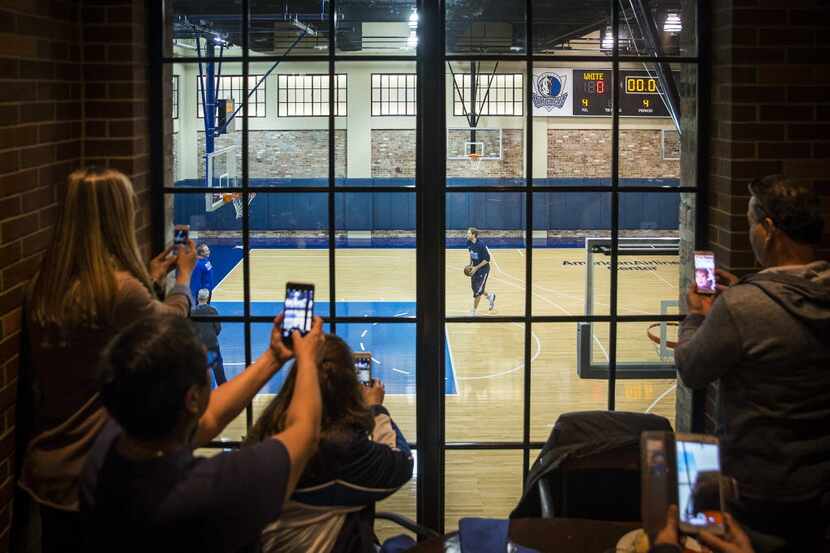 Fans watch from above in the Old No. 7 club as Dallas Mavericks forward Dirk Nowitzki warms...
