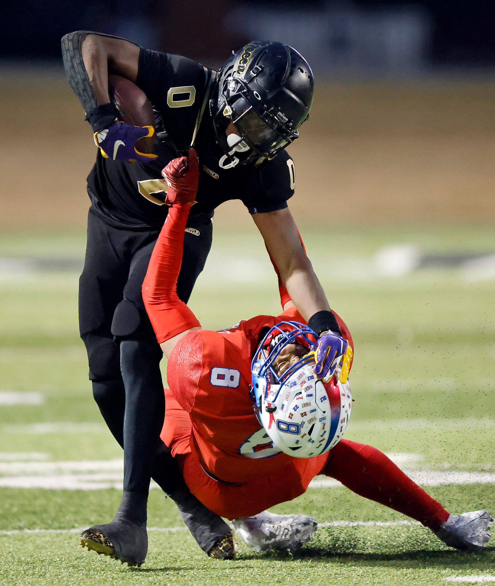 South Oak Cliff’s Jayvon Thomas gives a stiff arm to Midlothian Heritage’s Solomon Hopkins...