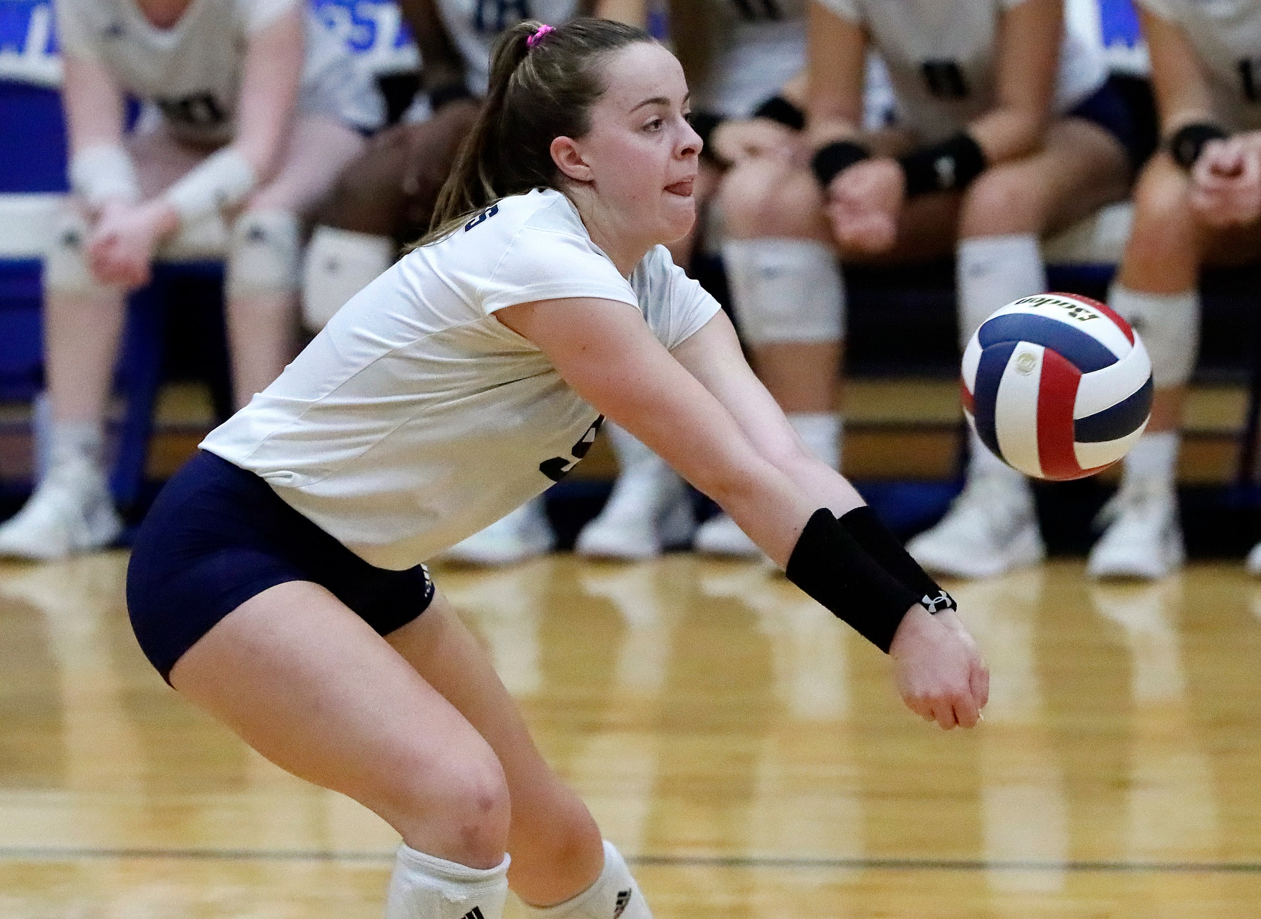 Flower Mound High School outside hitter Catherine Young (9) receives a serve during game one...