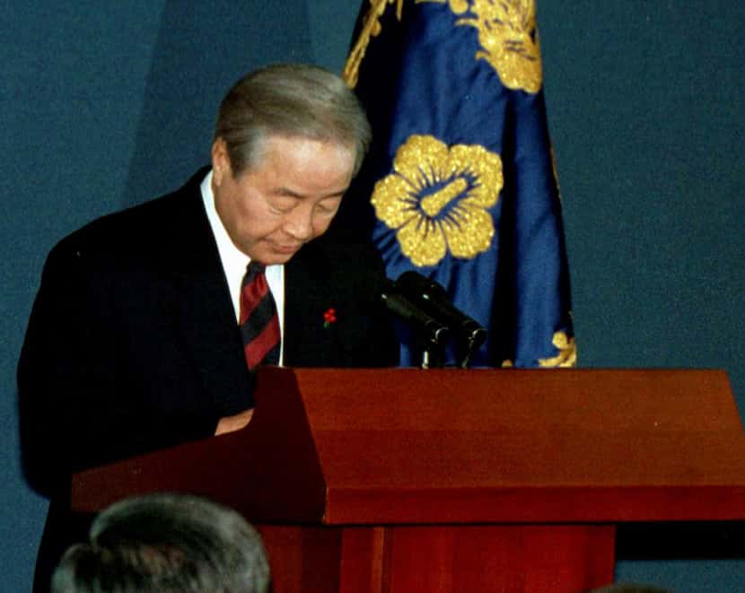 In this Dec. 11, 1997 file photo, South Korean President Kim Young-sam bows to the nation...