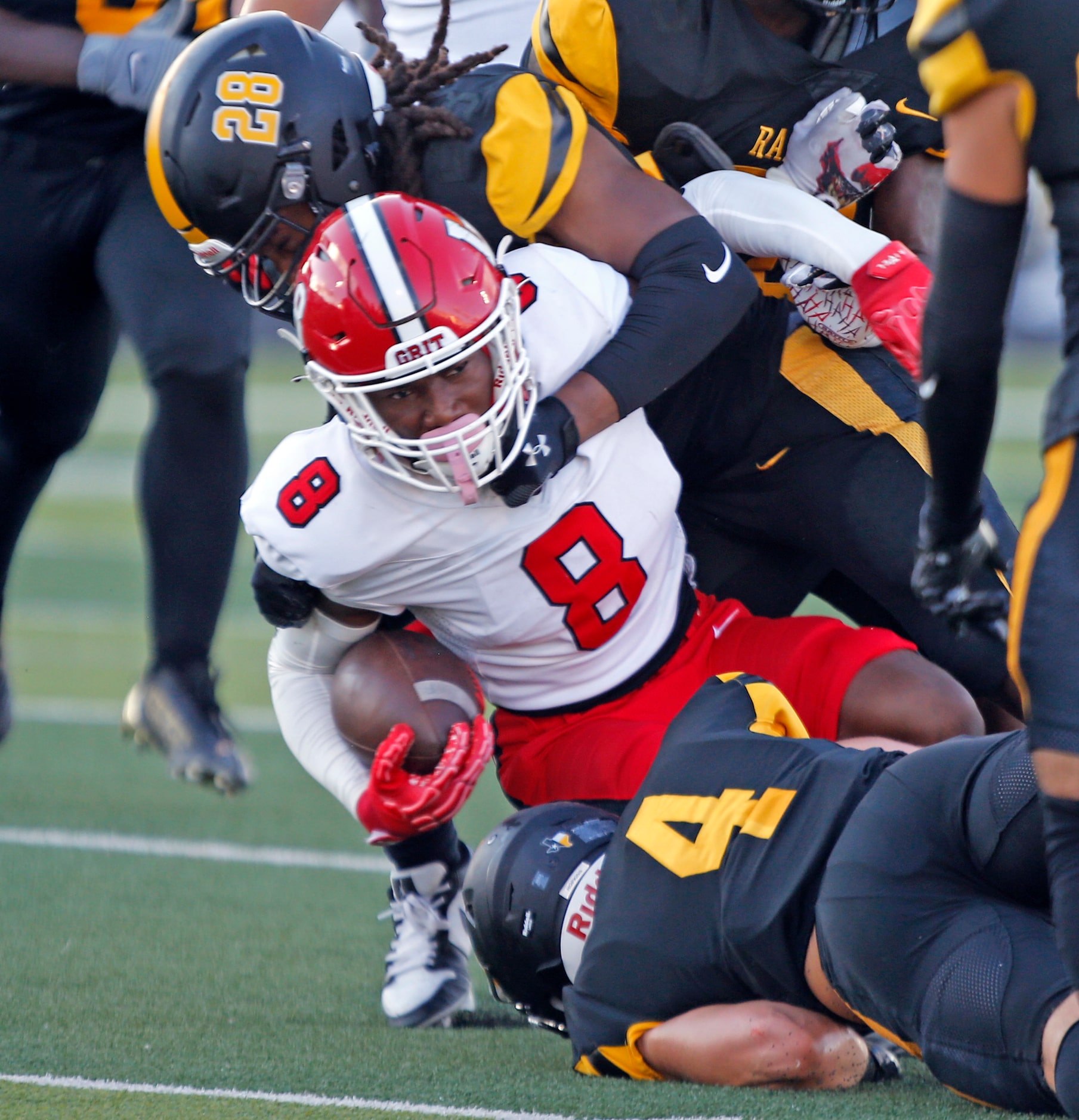 Lake Highlands Mo Kamara (8) is brought down by Forney defender Tyce Kennedy (28) during the...