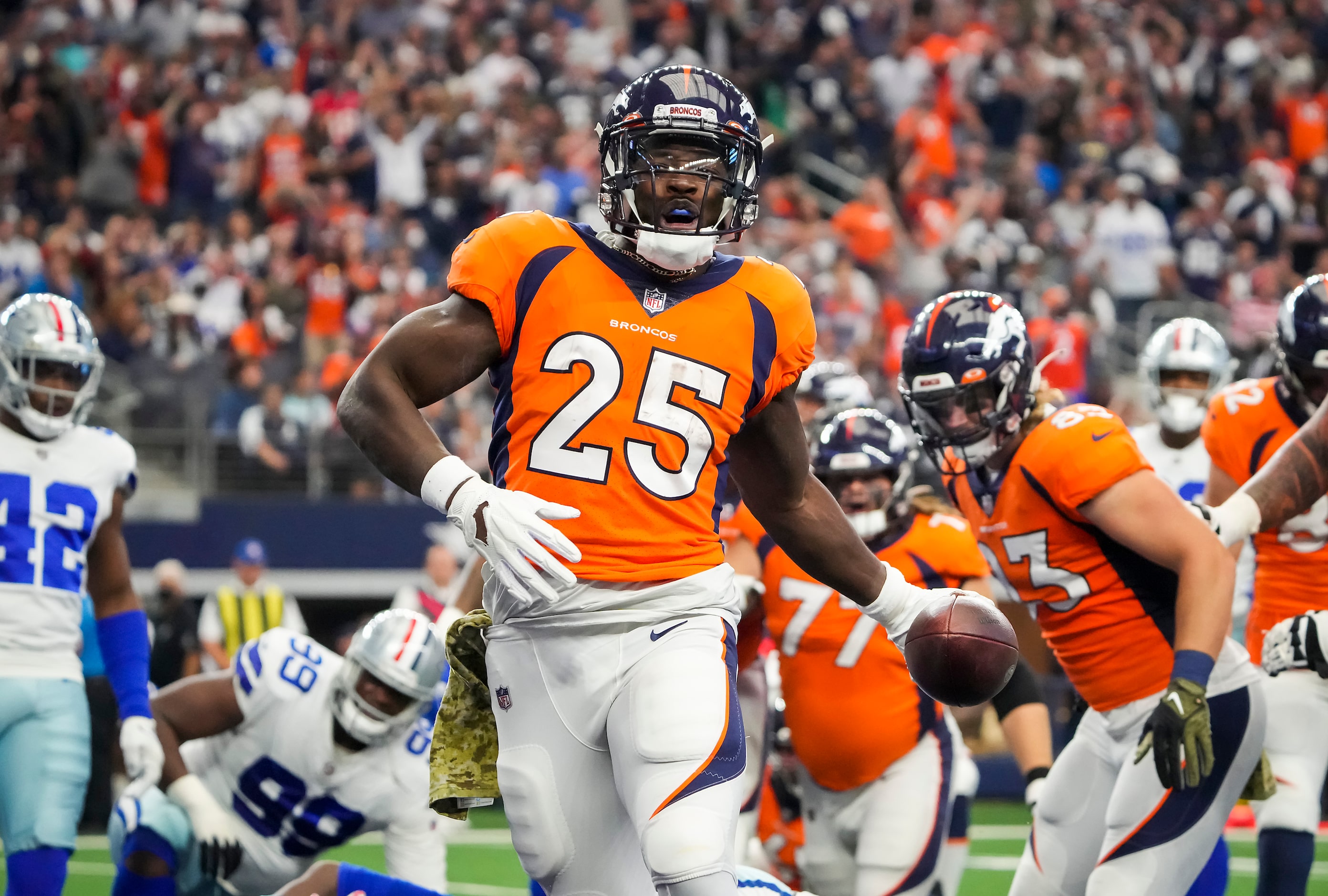 Denver Broncos running back Melvin Gordon (25) celebrates after scoring on a 3-yard...