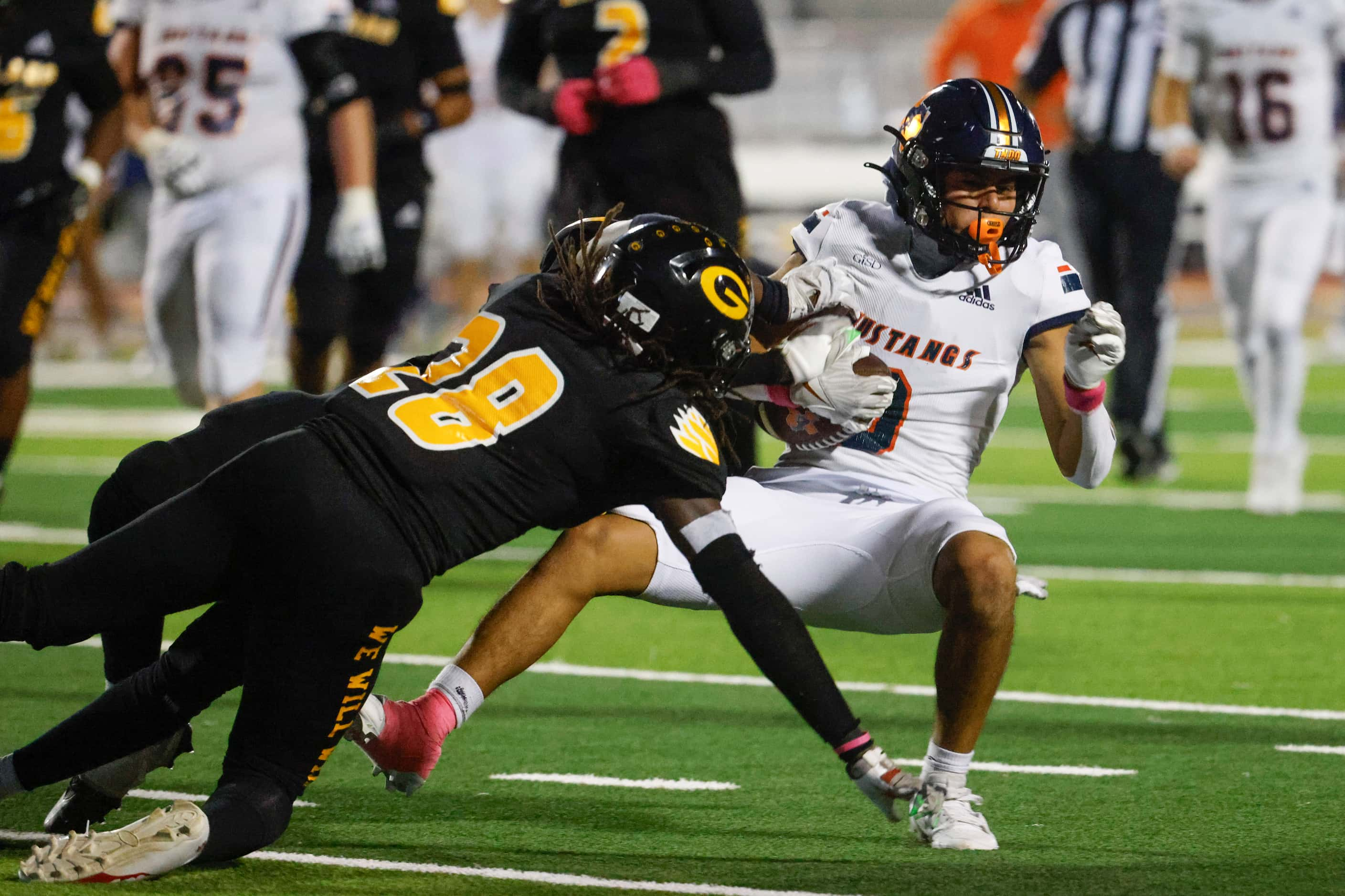 Garland High school’s Aiden Onchweri (left) tackles Sachse high school’s Fabian Ybarra...