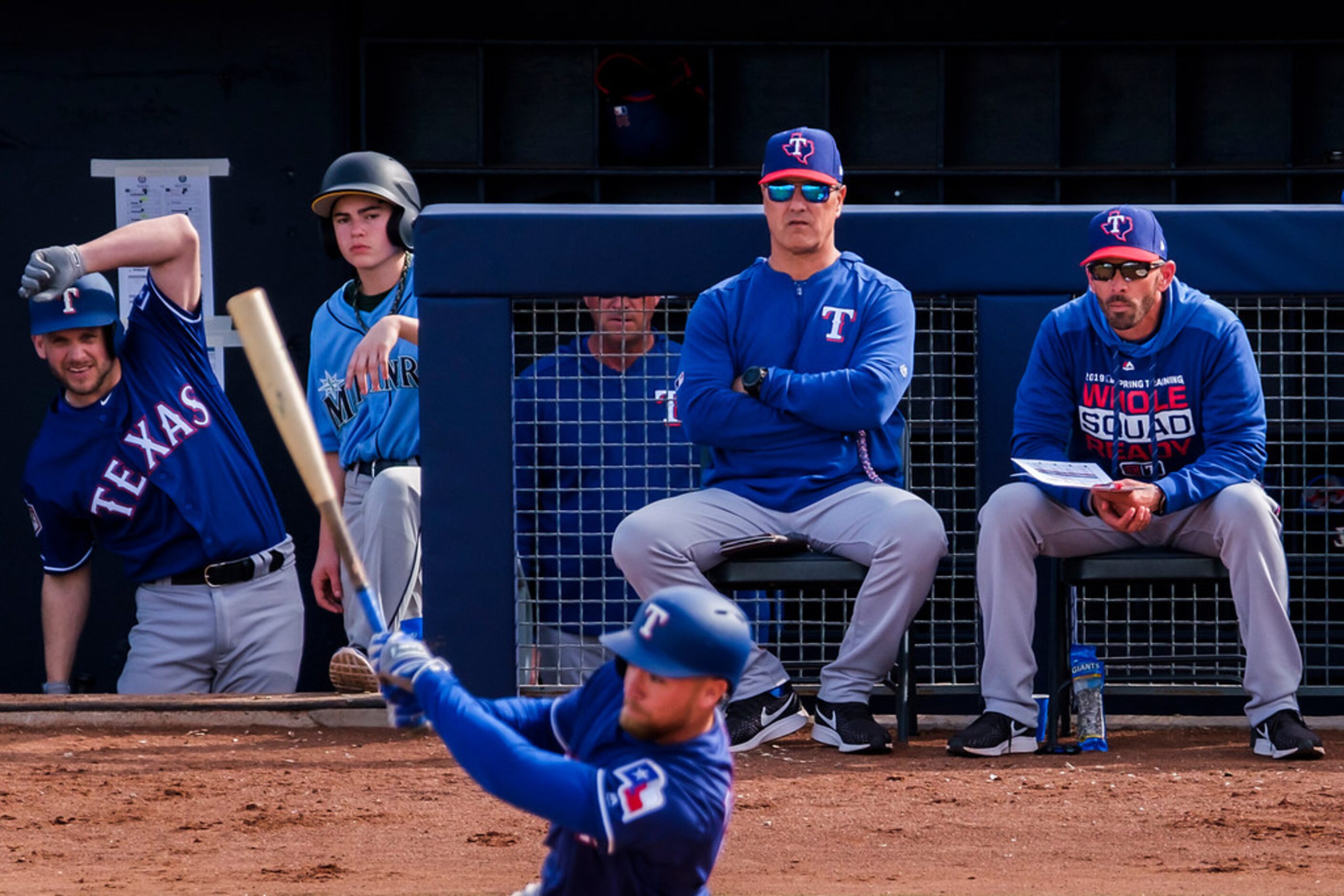 Texas Rangers bench coach Don Wakamatsu (center) and manager Chris Woodward (right) watch...