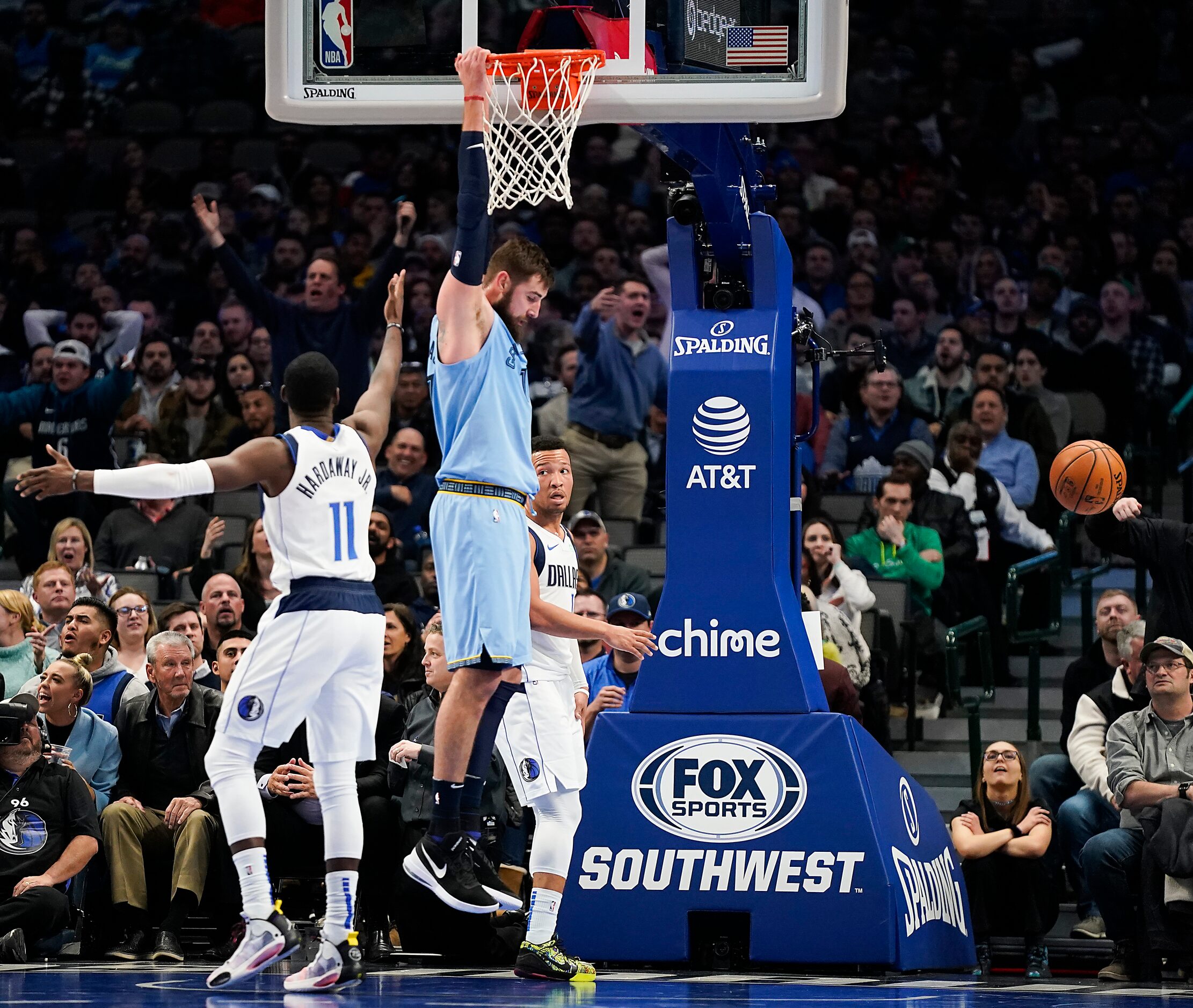 Memphis Grizzlies center Jonas Valanciunas (17) hangs from the basket after throwing down a...