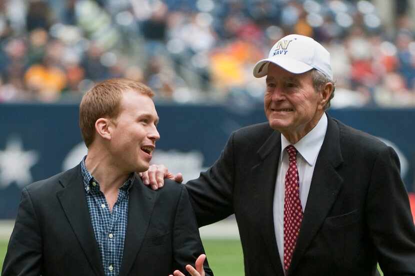 In this Dec. 31, 2009 photo, former President George H. W. Bush leaves the field with the...